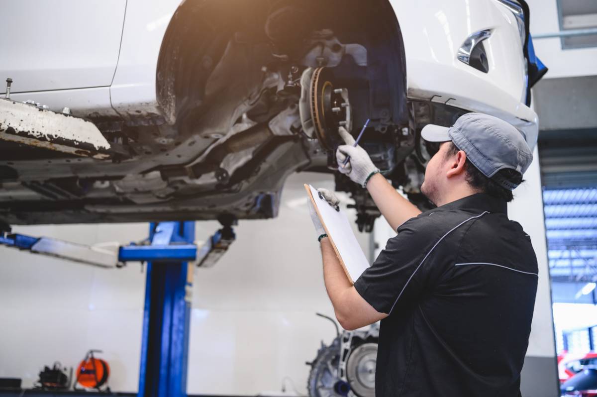 Un mécano qui check une voiture